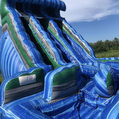 Buitenwaterpark Groot golfvormig opblaasbaar droog glijbaan met dubbele glijbanen in blauw PVC